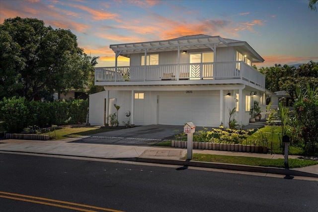 2825 Kauhale St, Kihei, HI 96753 - view of front of house featuring driveway, a balcony, and an attached garage