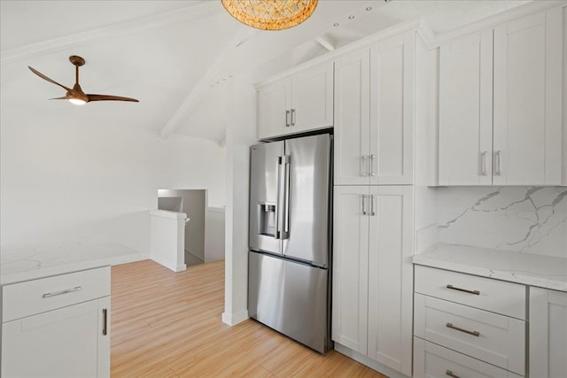 2825 Kauhale St, Kihei, HI 96753 - kitchen with stainless steel fridge with ice dispenser, light wood-type flooring, a ceiling fan, white cabinetry, and light stone counters