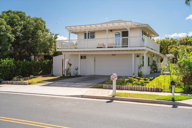 2825 Kauhale St, Kihei, HI 96753 - view of front facade featuring concrete driveway, a garage, and a balcony