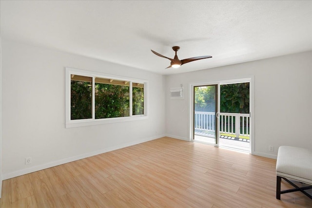 2825 Kauhale St, Kihei, HI 96753 - spare room with a ceiling fan, light wood-style floors, and a wall mounted air conditioner