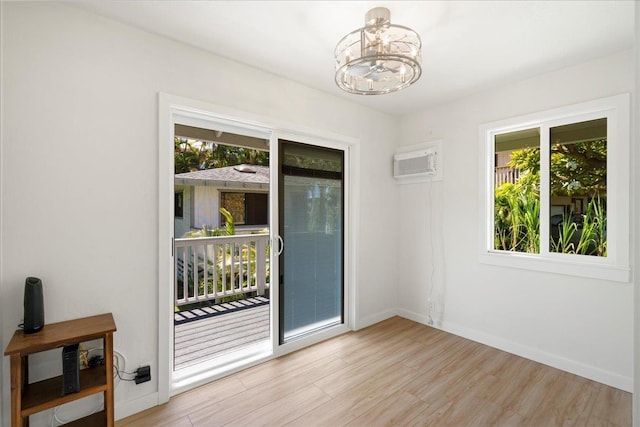 2825 Kauhale St, Kihei, HI 96753 - empty room featuring a chandelier, an AC wall unit, and light wood-type flooring