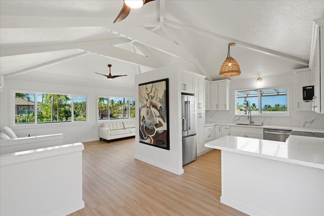 2825 Kauhale St, Kihei, HI 96753 - kitchen with open floor plan, a ceiling fan, appliances with stainless steel finishes, and decorative backsplash
