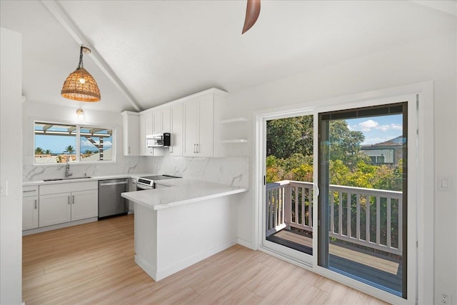 2825 Kauhale St, Kihei, HI 96753 - kitchen with stainless steel appliances, a peninsula, backsplash, and white cabinetry