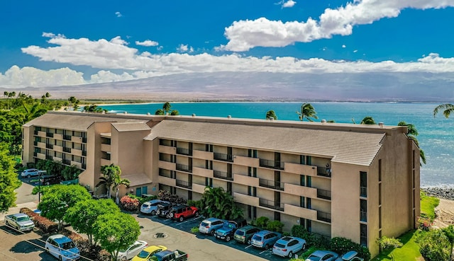 view of building exterior with a water and mountain view