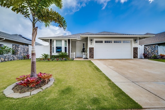 view of front of house featuring a front yard and a garage