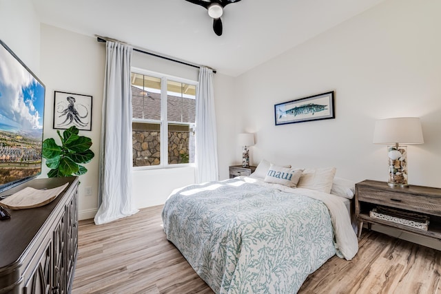 bedroom with light hardwood / wood-style flooring and ceiling fan