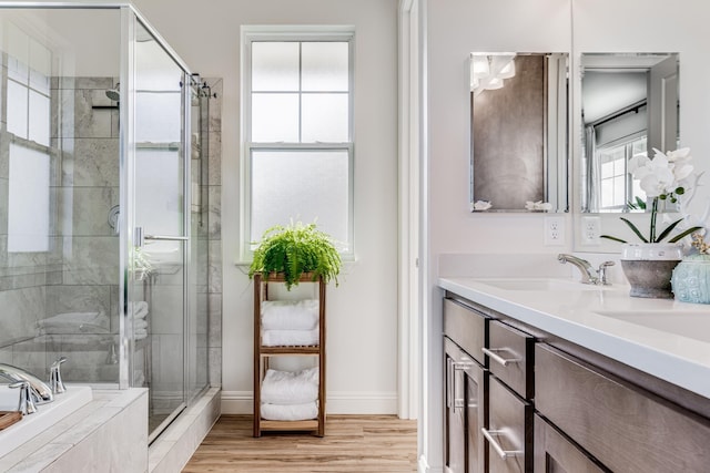 bathroom featuring wood-type flooring, vanity, and independent shower and bath