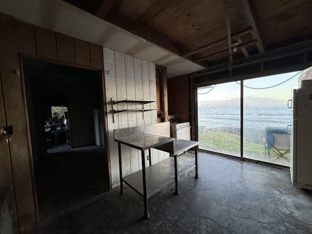 interior space featuring concrete floors and a water and mountain view