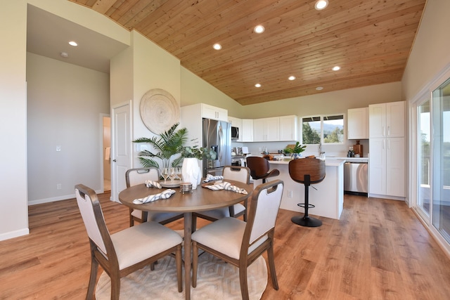 dining area with light hardwood / wood-style floors, wood ceiling, and high vaulted ceiling