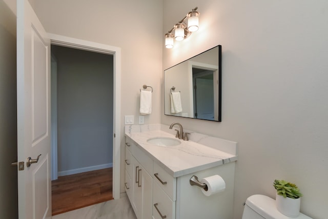 bathroom featuring hardwood / wood-style floors, vanity, and toilet