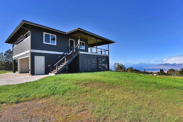 view of front of home with a garage and a front lawn