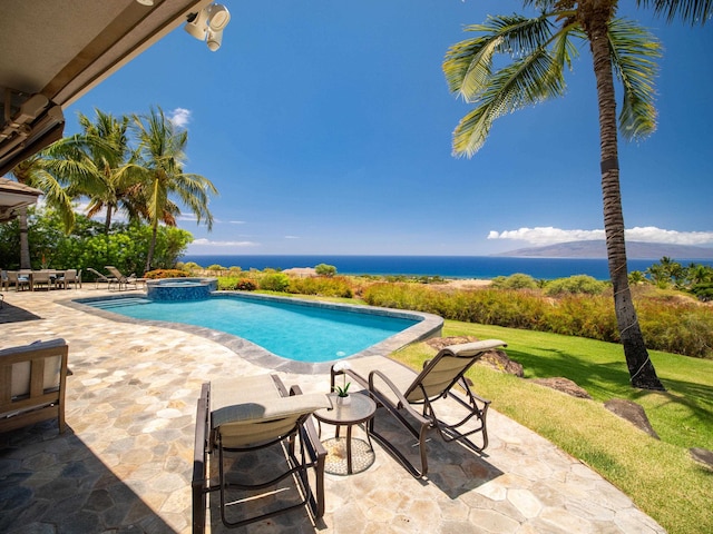 view of pool featuring an in ground hot tub, a water view, a lawn, and a patio area