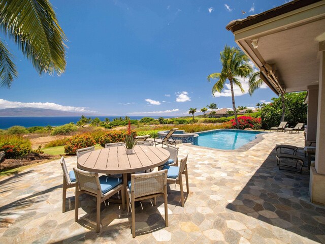 view of swimming pool featuring a patio area and a water view