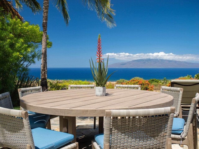 view of patio / terrace featuring a water and mountain view