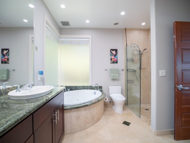 full bathroom with tile patterned flooring, shower with separate bathtub, toilet, and vanity