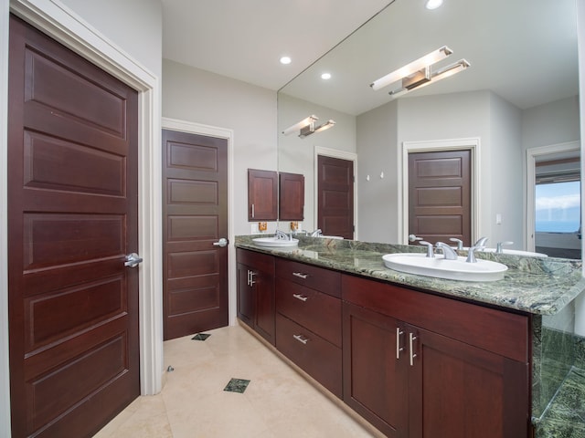 bathroom featuring dual vanity and tile patterned flooring