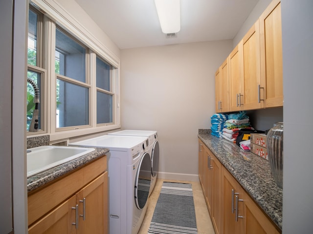 laundry room featuring cabinets, washer and clothes dryer, sink, and light tile patterned floors