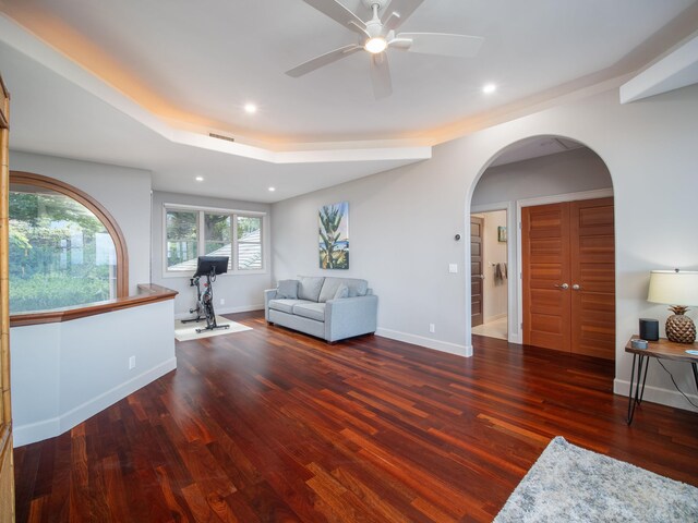 living room featuring wood-type flooring and ceiling fan