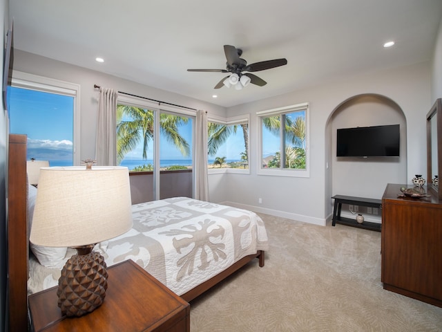 bedroom featuring access to outside, light carpet, and ceiling fan