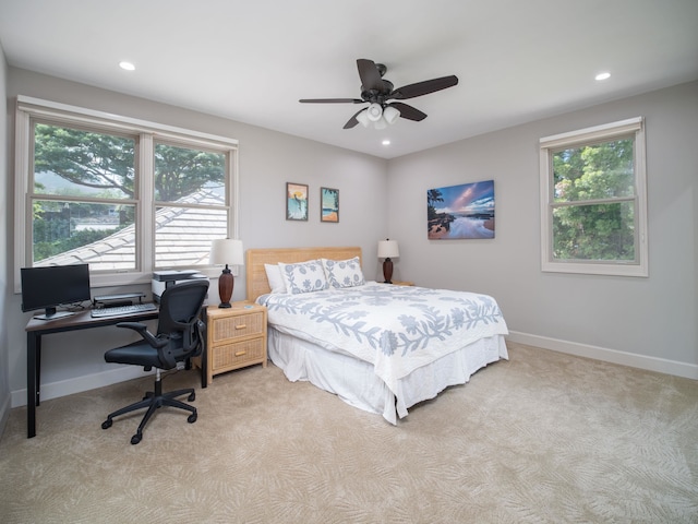 bedroom featuring light carpet and ceiling fan