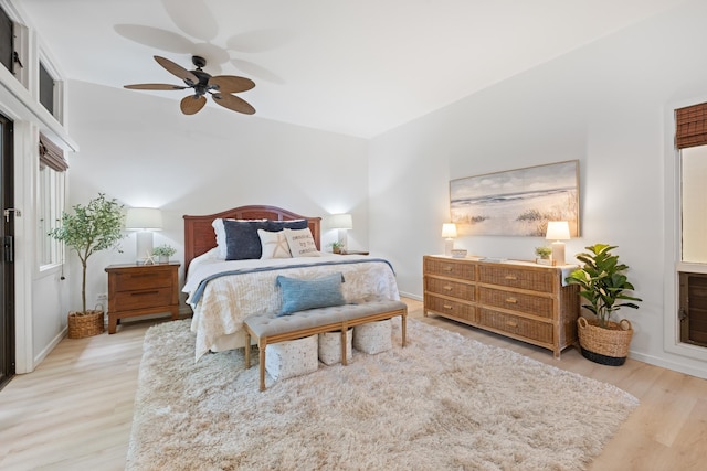 bedroom featuring baseboards, wood finished floors, and a ceiling fan
