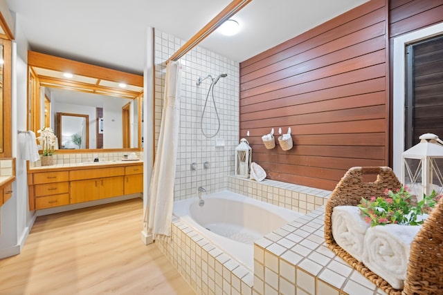 full bathroom with wood finished floors, tiled shower / bath, and vanity