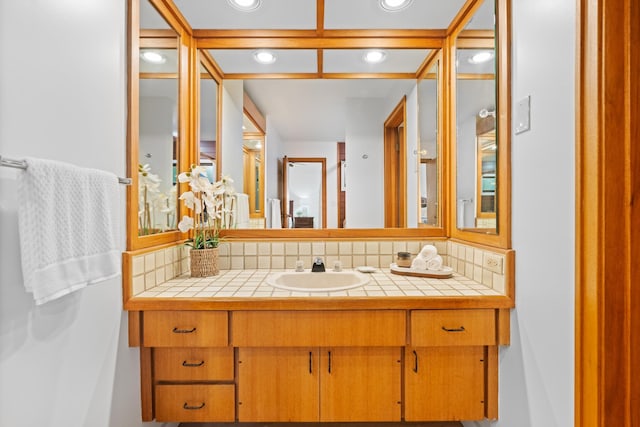 bathroom with recessed lighting, vanity, and tasteful backsplash