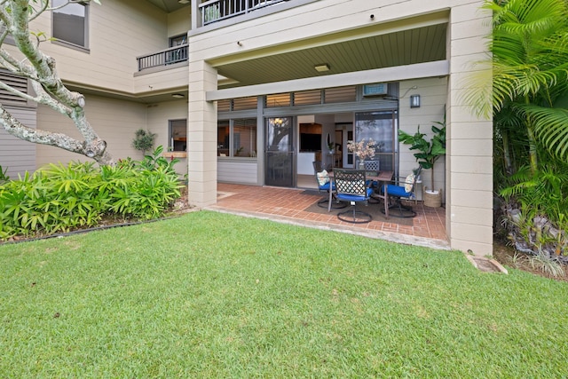 back of house with a patio and a yard