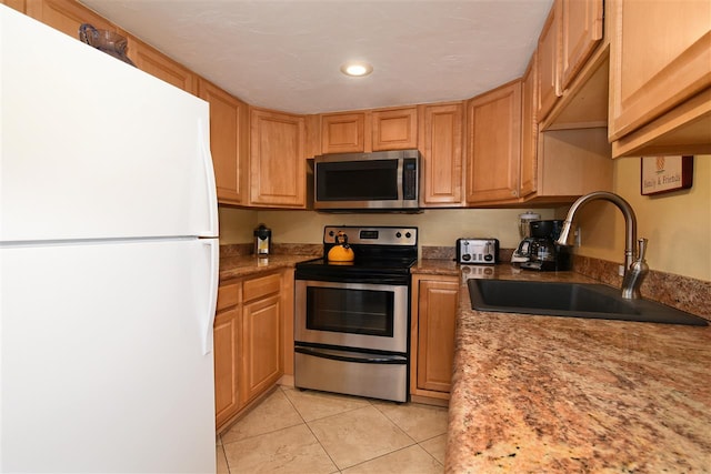 kitchen featuring appliances with stainless steel finishes, light tile patterned floors, and sink