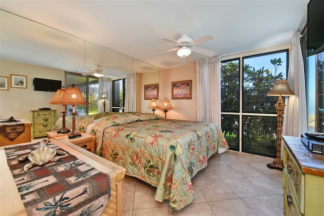 tiled bedroom with expansive windows and ceiling fan