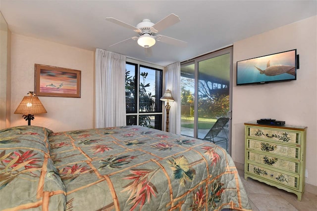 tiled bedroom featuring expansive windows, access to exterior, and ceiling fan