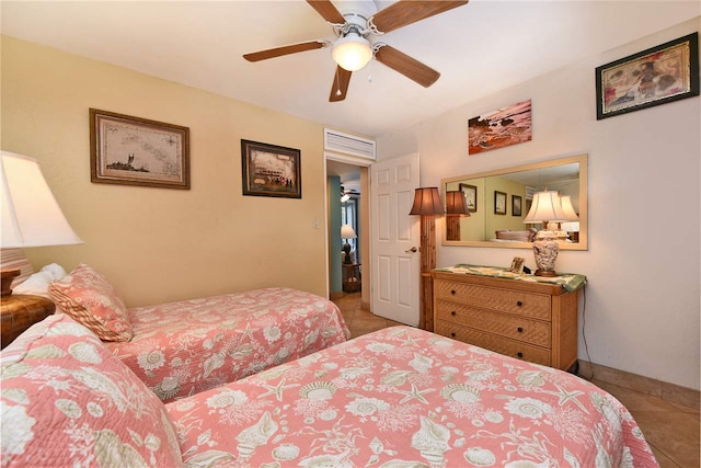 tiled bedroom with ceiling fan