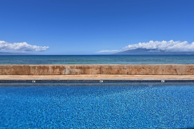 view of pool with a water and mountain view