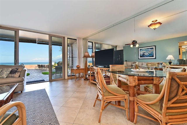 dining space featuring expansive windows, ceiling fan, and light tile patterned flooring