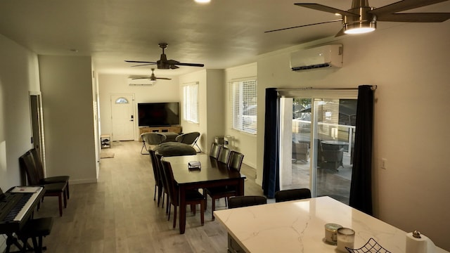 dining room with ceiling fan, light hardwood / wood-style flooring, and a wall unit AC