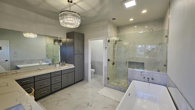 full bathroom with toilet, separate shower and tub, vanity, and a notable chandelier