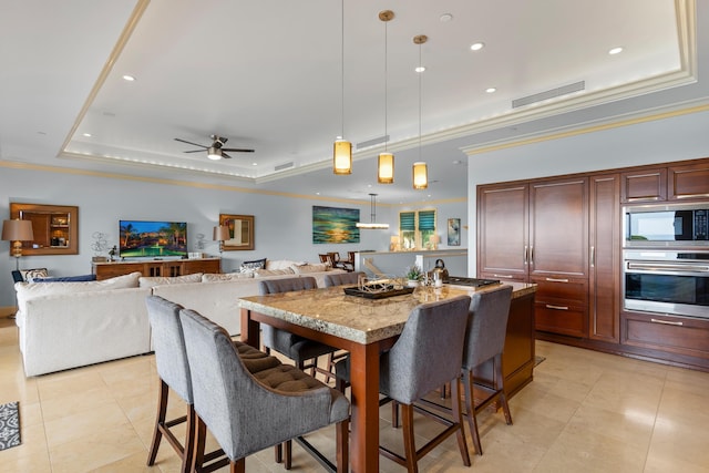 tiled dining space featuring pool table, ceiling fan, a tray ceiling, and ornamental molding