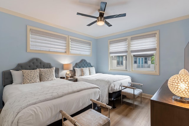 bedroom with ornamental molding, ceiling fan, and dark hardwood / wood-style flooring