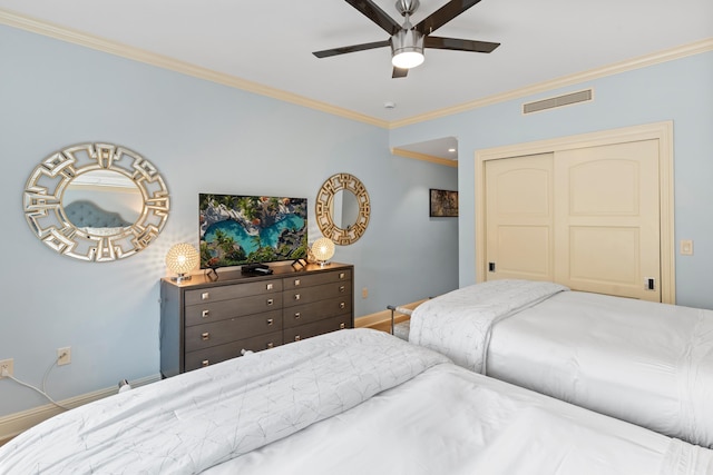 bedroom with a closet, ceiling fan, and crown molding