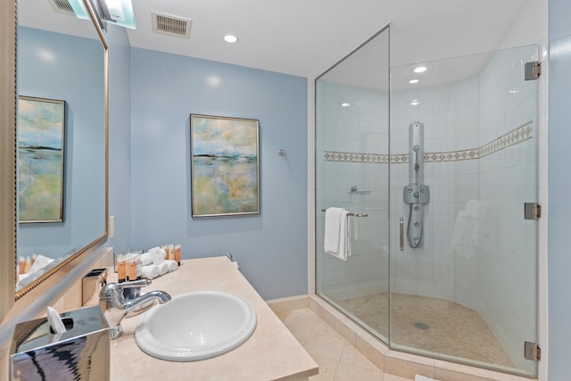 bathroom with vanity, tile patterned floors, and a shower with shower door