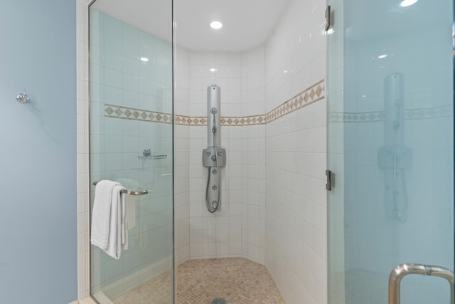 bathroom featuring a shower with shower door