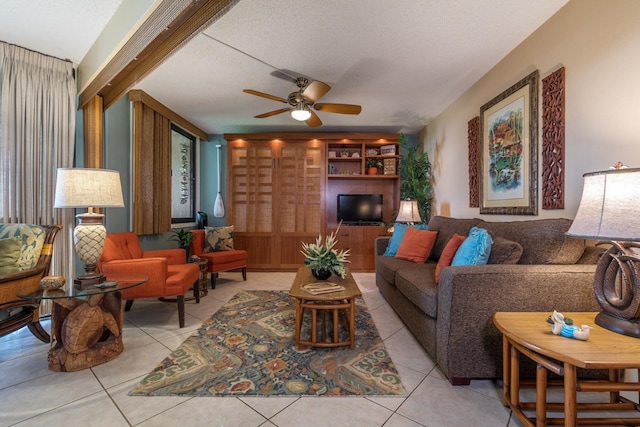 living room with light tile patterned floors, a textured ceiling, and a ceiling fan