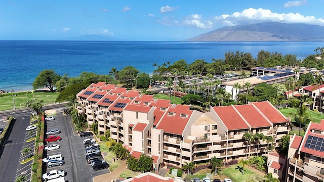 birds eye view of property with a water and mountain view