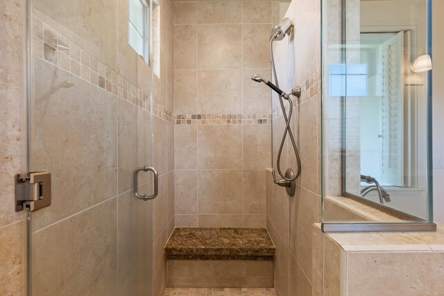 bathroom with a shower with door