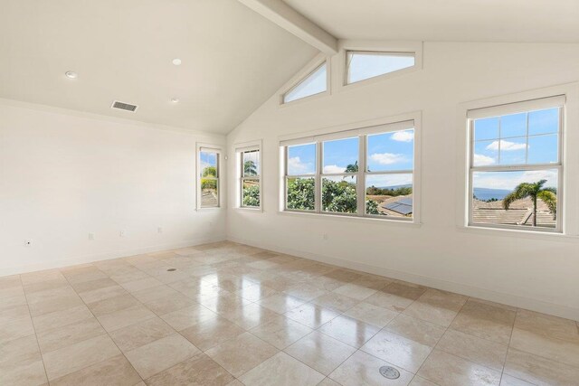 tiled spare room with vaulted ceiling with beams and plenty of natural light