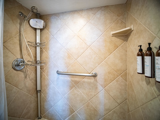 bathroom with tiled shower