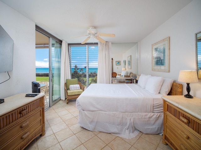 tiled bedroom with multiple windows, ceiling fan, access to outside, and a water view