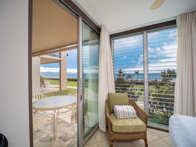 interior space featuring a water view and light tile patterned floors