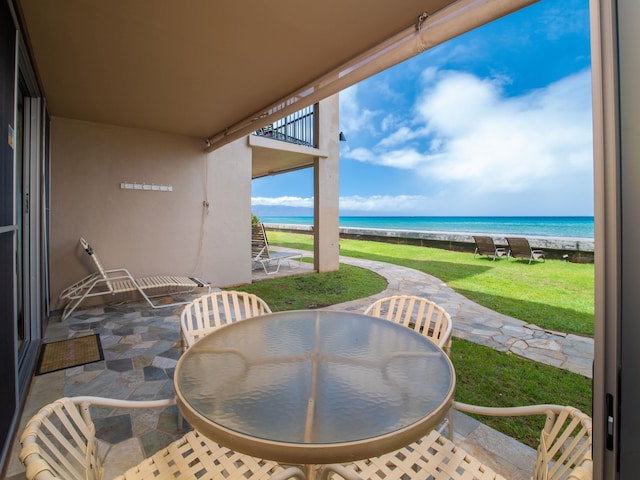 balcony with a patio and a water view