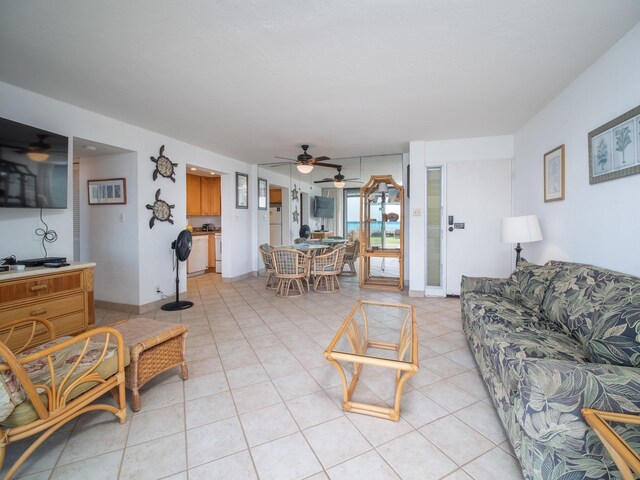 living room with ceiling fan and light tile patterned floors